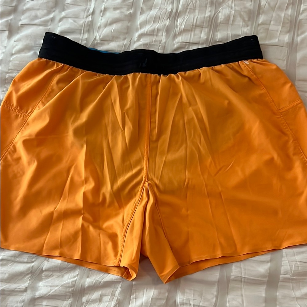 Orange Janji running Shorts with Black Waistband
